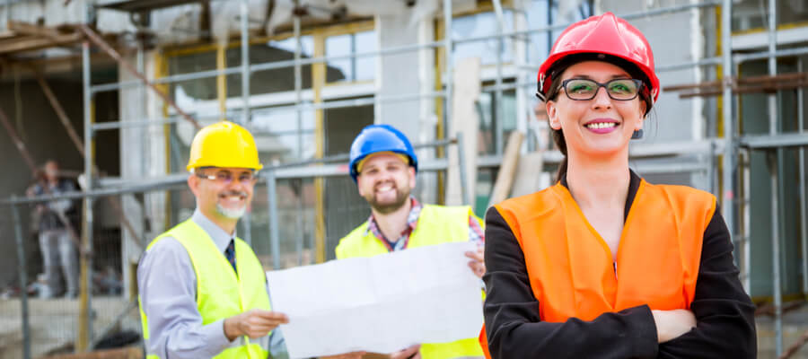 Construction woman standing in front of construction crew, OSHA competent person concept