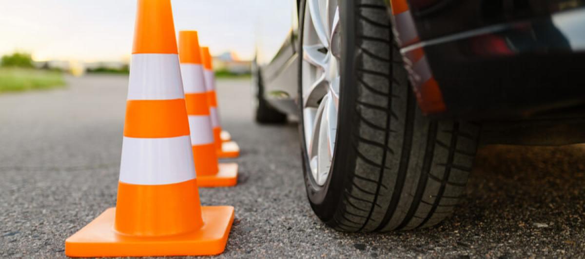 Car and traffic cones, driving school, defensive driving course concept