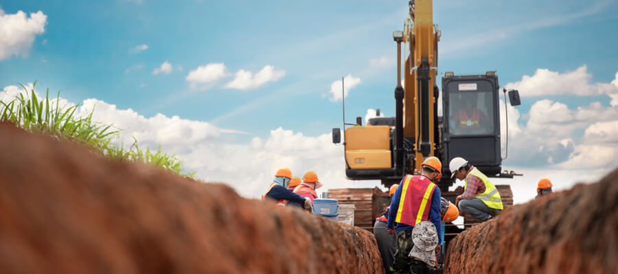 Group of workers and construction engineer wearing safety uniform