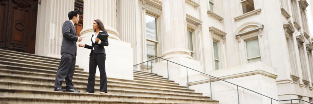 Two government officials talking on footsteps of government building