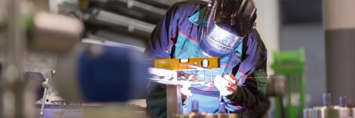 Manufacturing Safety and Risk management, man welding in shop