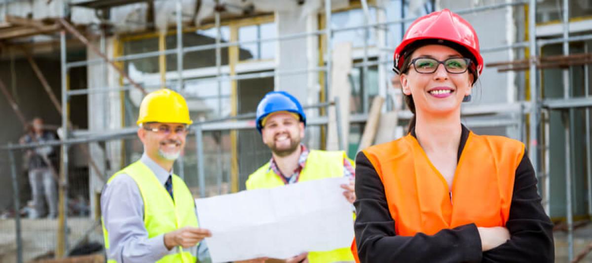 Construction woman standing in front of construction crew, OSHA competent person concept