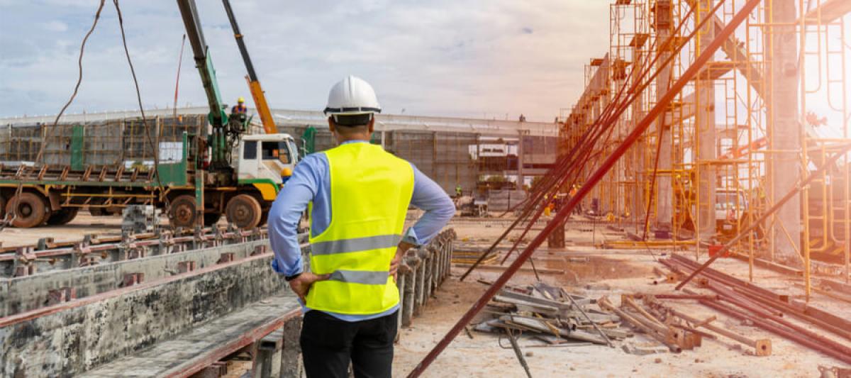 OSHA supervisor overlooking the construction of a tower crane 