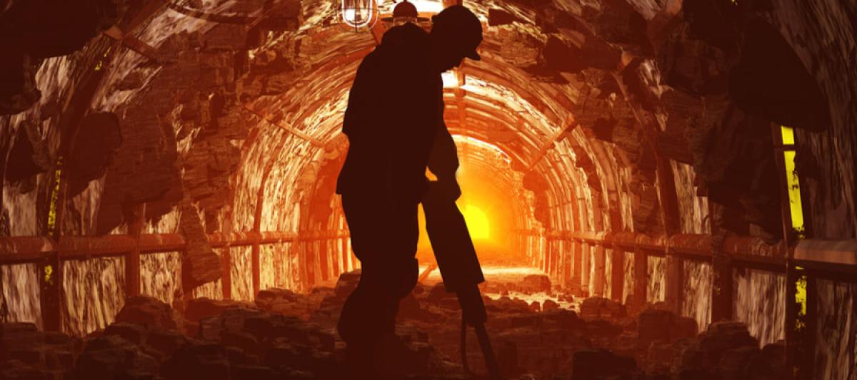 silhouette of worker in an underground mine